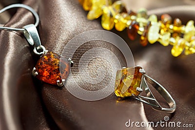 Closeup jewelry with authentic natural baltic amber : silver ring and pendant Stock Photo