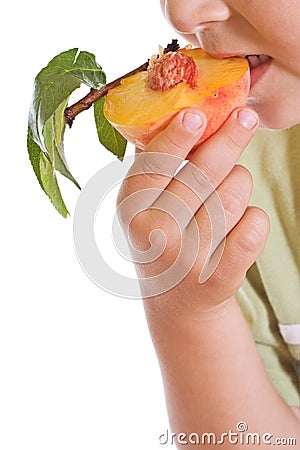 Closeup of kid eating a half peach Stock Photo