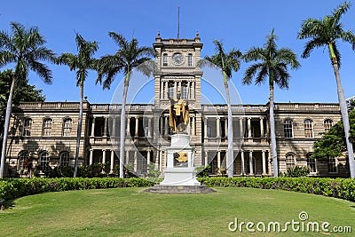 Closeup of King Kamehameha statue in downtown Honolulu, with Iolani palace background Editorial Stock Photo