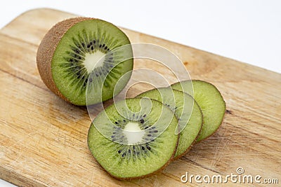 Closeup Kiwi fruit slice on the old wood butcher Stock Photo