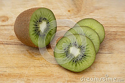 Closeup Kiwi fruit slice on the old wood butcher Stock Photo