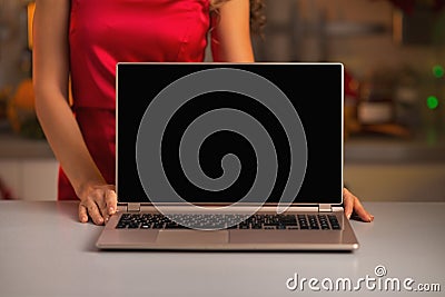 Closeup on laptop blank screen showing by woman in kitchen Stock Photo