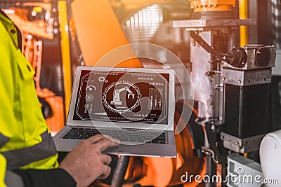 closeup laptop computer screen display software program control operate industry robot arm machine in automation factory Stock Photo