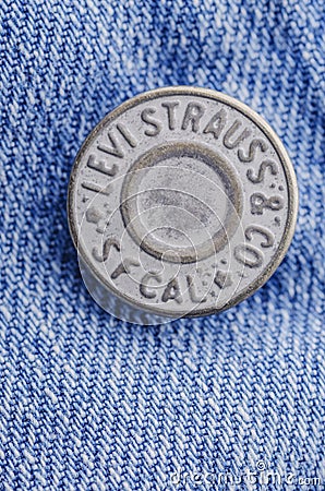 Closeup of Levi Strauss button on blue jeans. Editorial Stock Photo