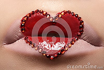 Closeup lips with red heart make-up & rhinestones. Valentines Day style Stock Photo