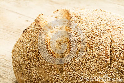 Closeup of a loaf of homemade bread with sesame seeds in selective focus Stock Photo