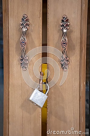 Closeup on locked padlock on wooden door Stock Photo