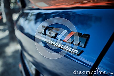 Closeup of the logo of a Blue BMW X6 sports SUV on the backside of the car with a blurry background Editorial Stock Photo