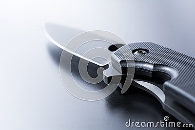 Closeup Of A Lying Opened Military Knife On Dark Ground Stock Photo