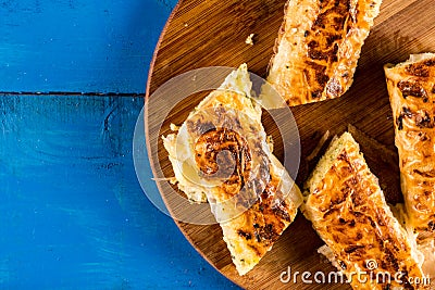 Closeup macro flat lay domestic cheese pie slices served on the round board Stock Photo