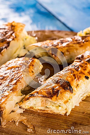 Closeup macro flat lay domestic cheese pie slices served on the round board Stock Photo