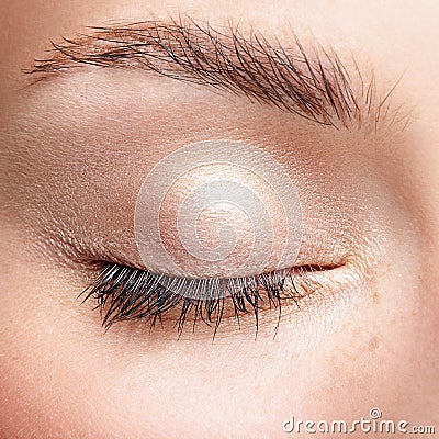 Closeup macro shot of closed human female eye with natural day f Stock Photo