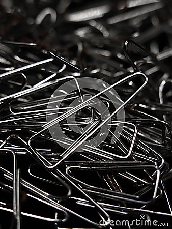 a large pile of triangular shaped shiny silver paper clips Stock Photo