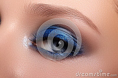 Closeup Macro of Woman Face with Blue Eyes Make-up. Fashion Celebrate Makeup, Glowy Clean Skin, perfect Shapes of Brows Stock Photo