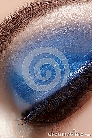 Closeup Macro of Woman Face with Blue Eyes Make-up. Fashion Celebrate Makeup, Glowy Wet Eye Shadows and Black Eyelashes Stock Photo