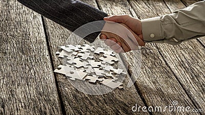 Closeup of male and female business partners shaking hands over Stock Photo