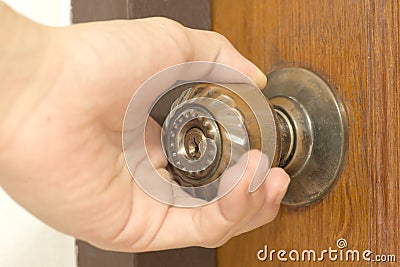 Closeup of male hand opening door knob Stock Photo