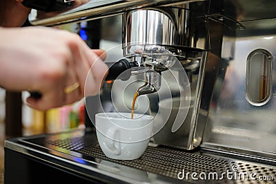 Closeup of a man barista brewing an espresso using a coffee mach Stock Photo