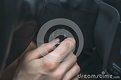 Closeup of man driver hand inserts key in ignition lock Stock Photo