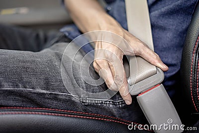 Closeup of man fastening seat belt in car, Safety belt safety first Stock Photo