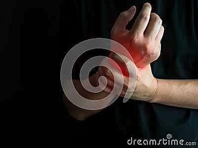 Closeup man holds he wrist hand injury, feeling pain. Health care and medical conept Stock Photo