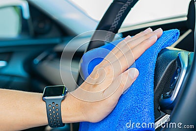 Closeup for man polishing cleaning car steering wheel with microfiber cloth Stock Photo