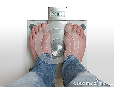 Man`s feet on weight scale - Lose weight Stock Photo