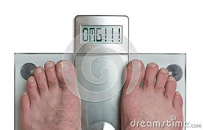 Man`s feet on weight scale - OMG Stock Photo