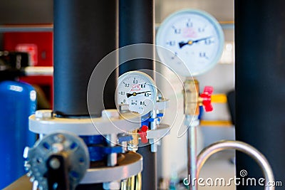 Closeup of manometer, measuring gas pressure. Pipes and valves at industrial plant. Pressure gauge, measuring instrument close up Stock Photo