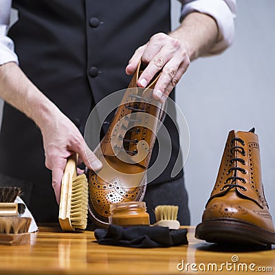 Closeup of Mans Hands Cleaning Luxury Calf Leather Brogues with Special Accessories And Tools Stock Photo