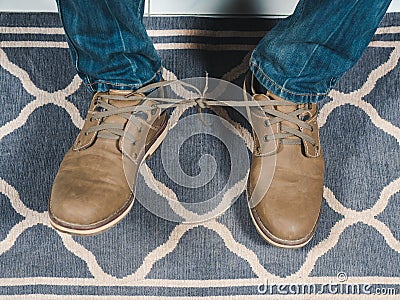 Closeup mans shoelaces tied together, April fools day Stock Photo