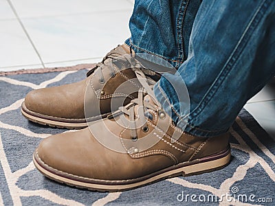 Closeup mans shoelaces tied together, April fools day Stock Photo