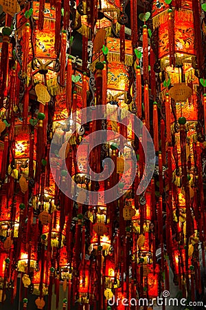 Closeup of many lit red lamps/lanterns in a temple Stock Photo