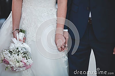 Closeup of a marrying couple holding hands during the wedding ceremony Stock Photo