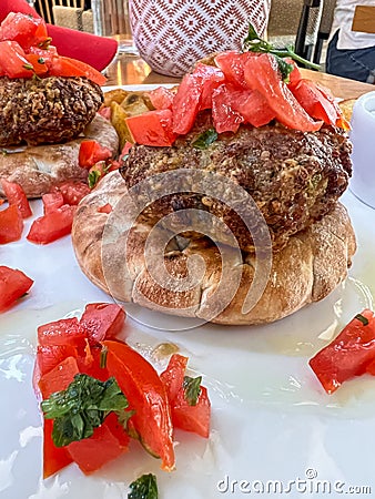 Closeup meatballs served on pita bread with tomato salad on plate Stock Photo