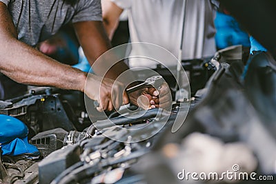 Closeup mechanic hand using tool fix service car underhood engine oil replace in auto garace Stock Photo