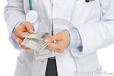 Closeup on medical doctor counting dollars Stock Photo