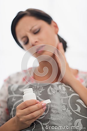 Closeup on medicine bottle and girl with toothache Stock Photo