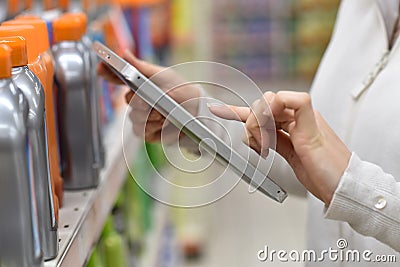 Closeup of merchandiser using tablet in shop Stock Photo