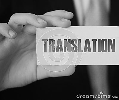 Translation word on card in hand of businessman. Global business concept Stock Photo