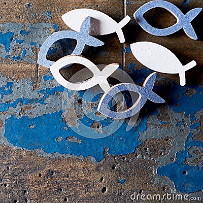 Metal Christian fish shapes on wood background Stock Photo