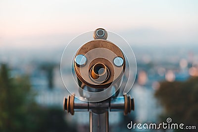 Closeup of a metallic telescope against blurred city Stock Photo