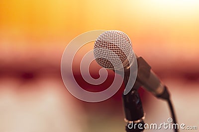 Closeup of microphone on abstract blurred background speech in seminar convention hall room and light as guest and conference Stock Photo