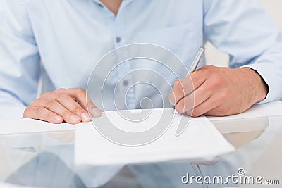 Closeup mid section of a man writing documents Stock Photo