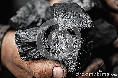 Closeup Miner holds coal palm. Concept mining, Top view Stock Photo