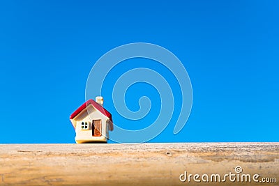Closeup miniature house on blue sky background using as property Stock Photo