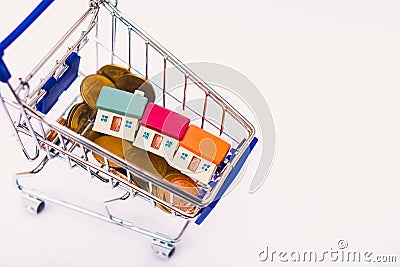 Closeup miniature house with golden stack coins Stock Photo