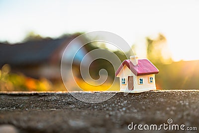 Closeup miniature house on sunset background using as property a Stock Photo