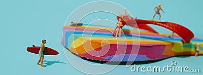 Miniature men and rainbow flip-flop, banner Stock Photo