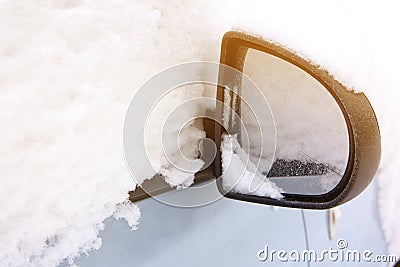 closeup mirror Snow on cars after snowfall. Winter urban scene with sun flare Stock Photo